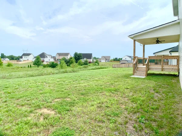 a view of a house with a yard and sitting area