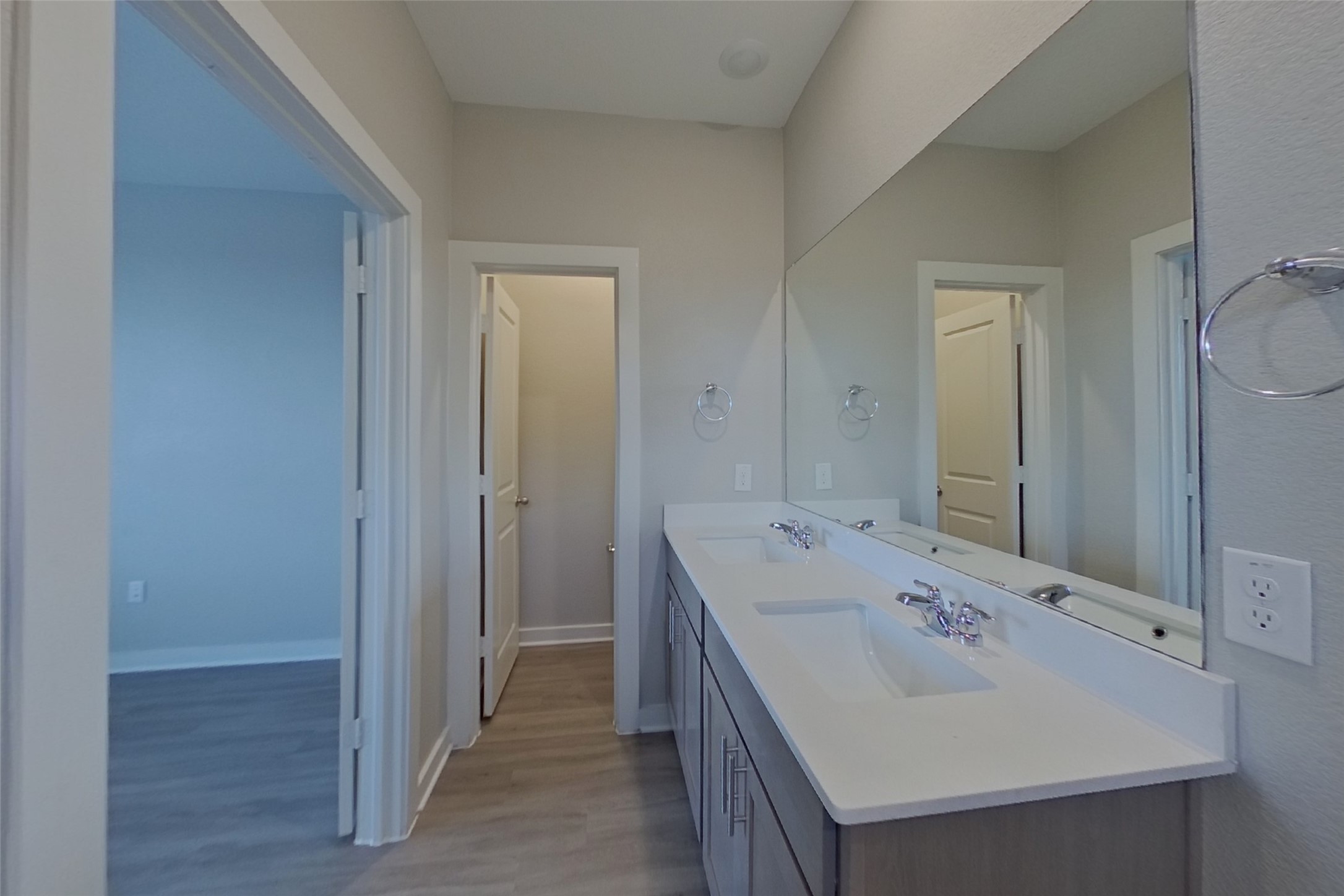 445 Raglands Road Leander, TX 78641 - Photo 10 of 17 Double vanity with sleek countertops offers ample space in this well-appointed primary bathroom.
