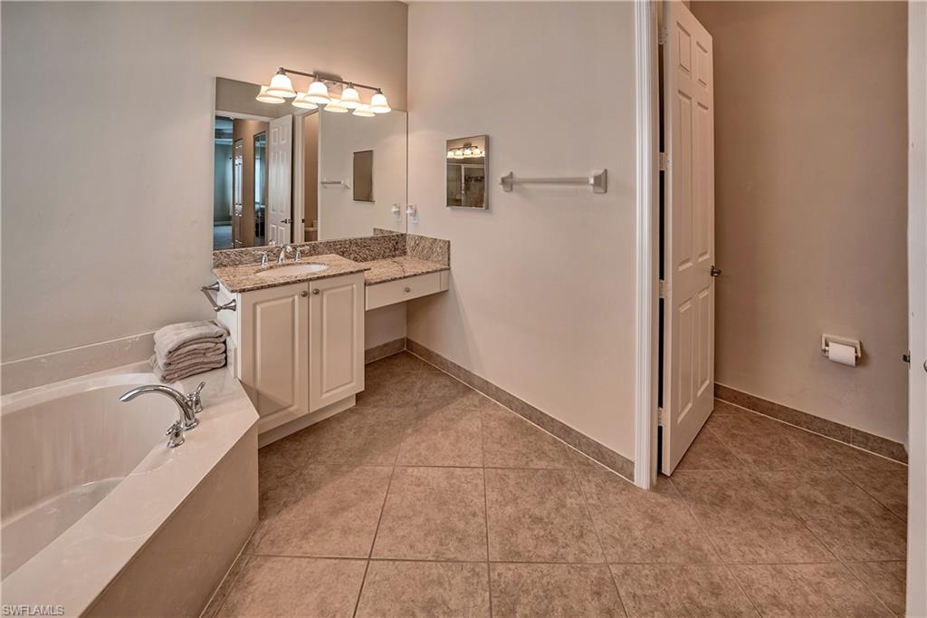 6623 Monterey Point Naples, FL 34105 - Photo 13 of 34 a bathroom with a bathtub sink and mirror