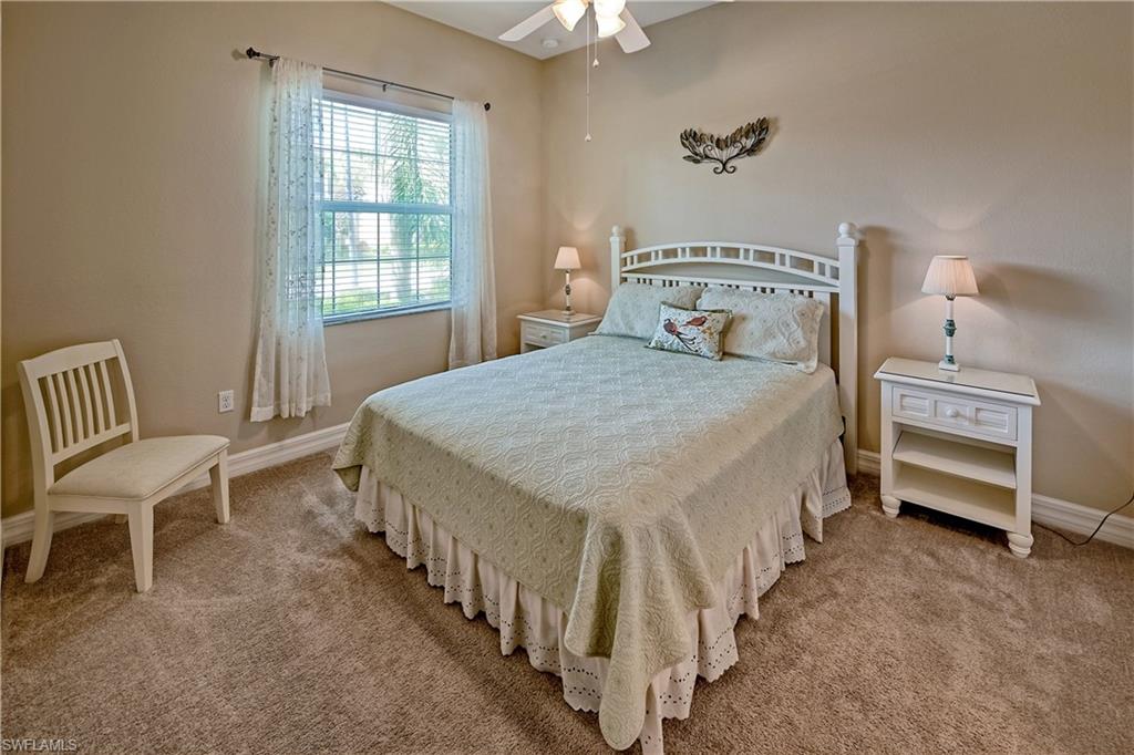 6623 Monterey Point Naples, FL 34105 - Photo 18 of 34 a bedroom with a bed and a chair