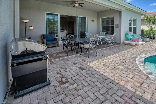 a view of outdoor kitchen with seating area