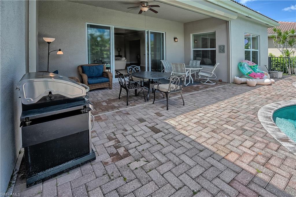 6623 Monterey Point Naples, FL 34105 - Photo 26 of 34 a view of outdoor kitchen with seating area