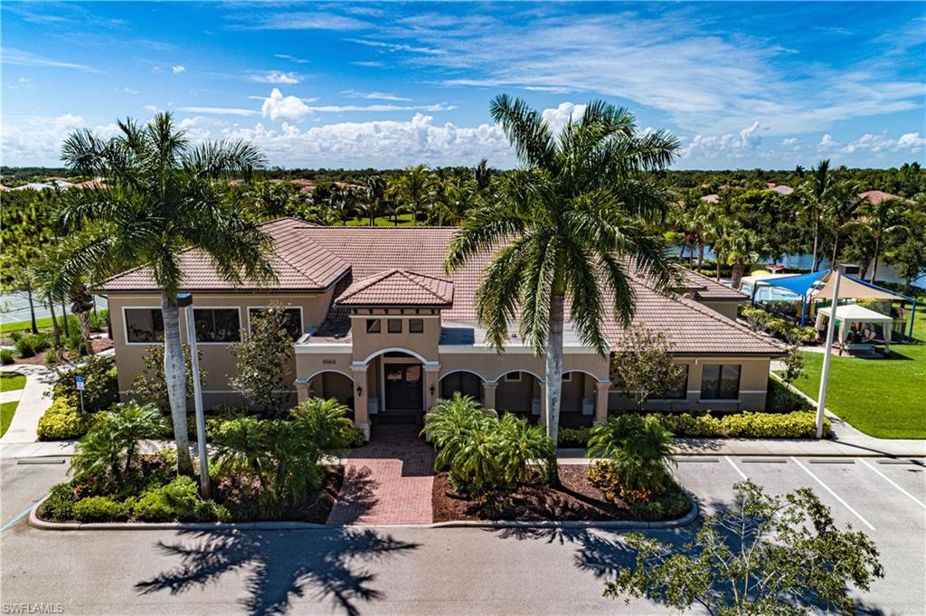 6623 Monterey Point Naples, FL 34105 - Photo 29 of 34 a front view of a house with a garden