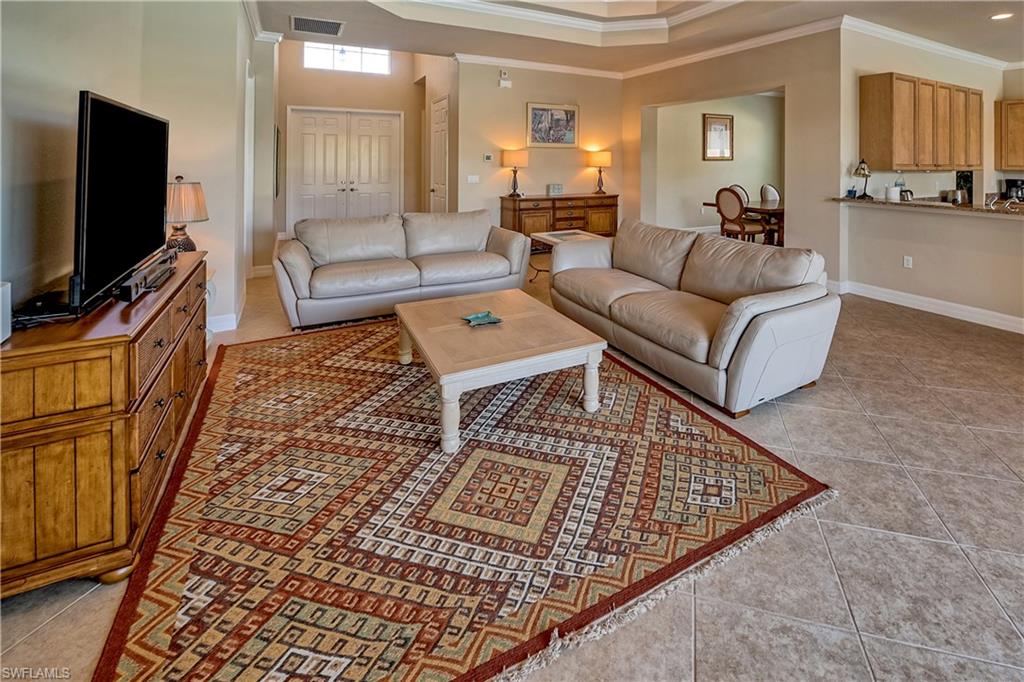 6623 Monterey Point Naples, FL 34105 - Photo 6 of 34 a living room with furniture and a flat screen tv