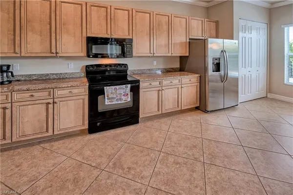 a kitchen with a stove a sink and a refrigerator