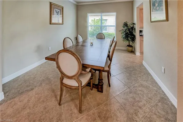 a dining room with furniture and window