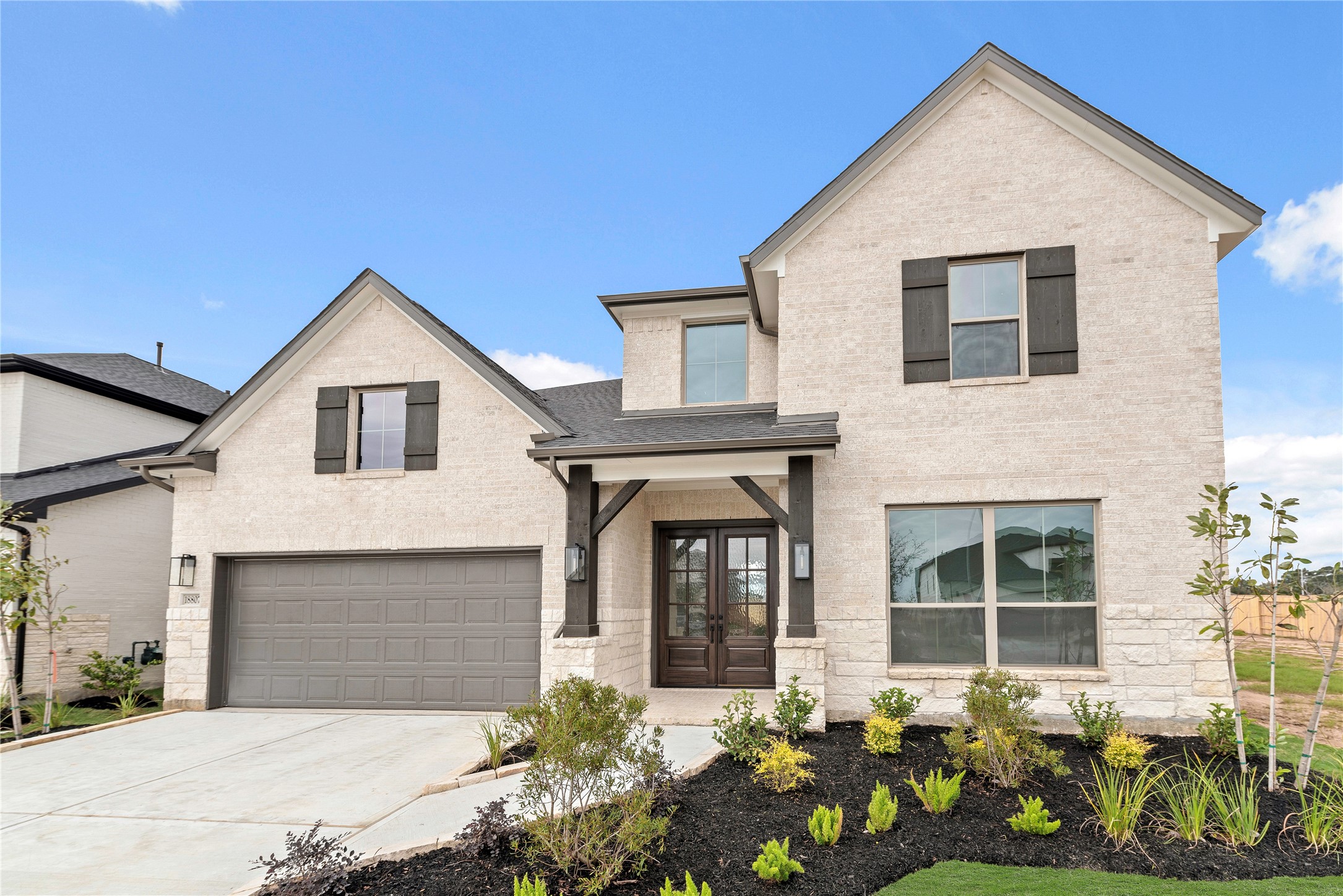 a front view of a house with a garden