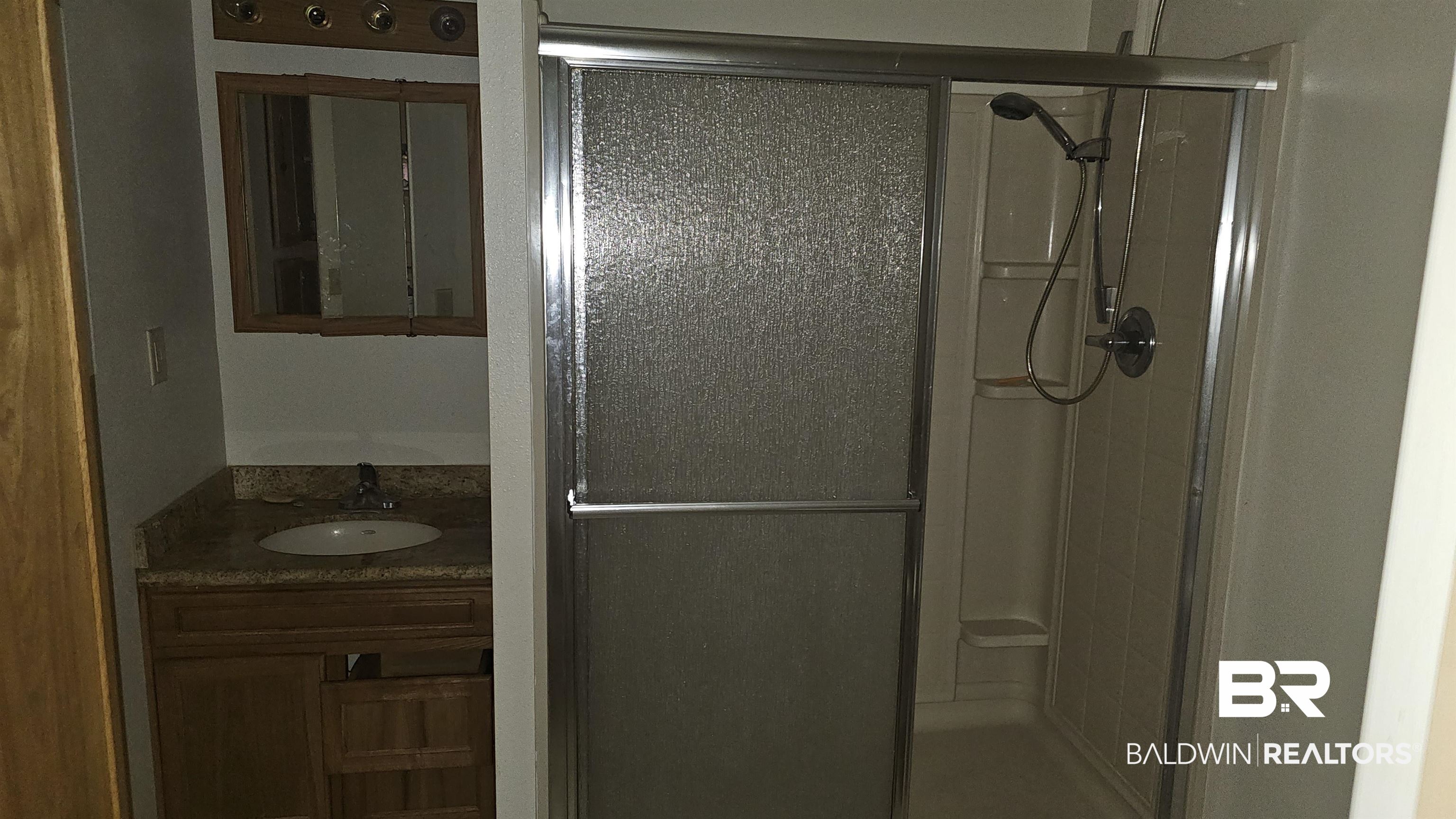 307 Scott Street Brewton, AL 36426 - Photo 5 of 19 Bathroom featuring a shower with shower door and vanity