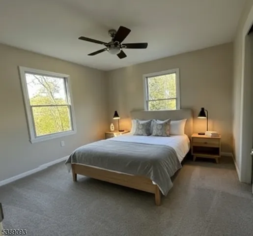 a spacious bedroom with a bed and a chandelier