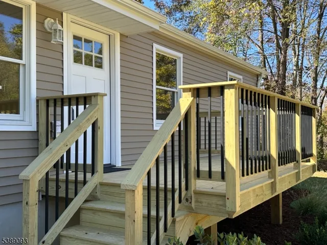 a view of balcony with wooden floor and fence
