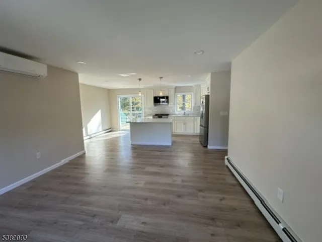 a view of a kitchen with a sink and wooden floor
