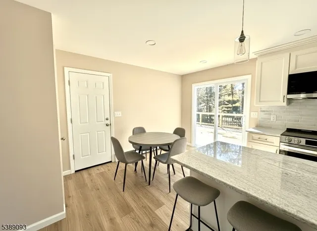 a dining room with furniture and wooden floor