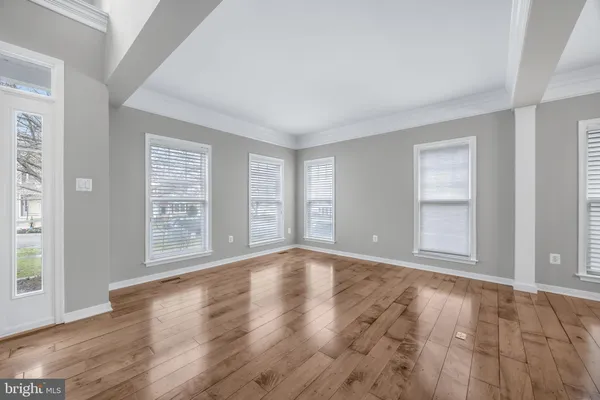 a view of an empty room with a fireplace and a window