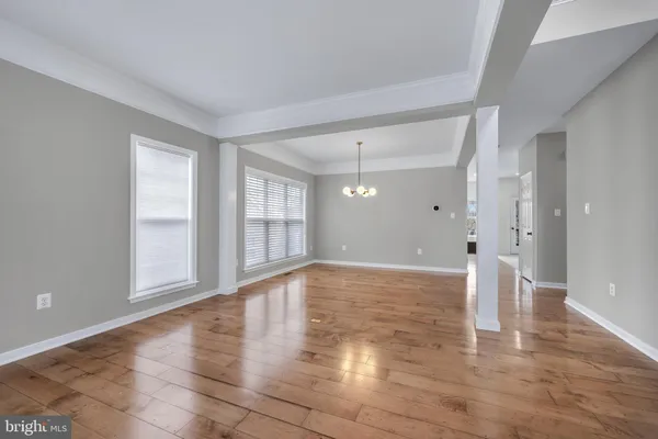 a view of an empty room with a fireplace and a window