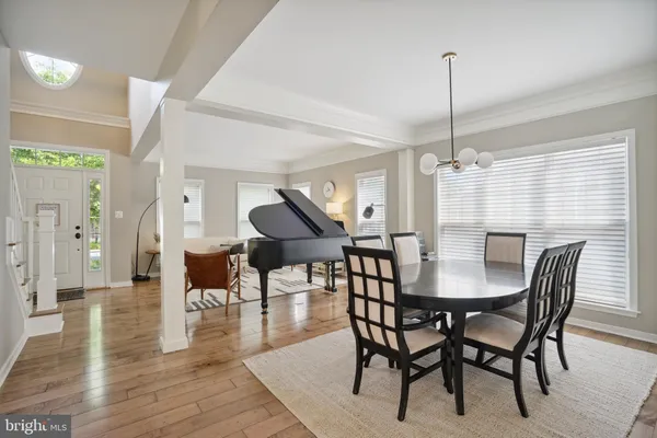 a kitchen with stainless steel appliances granite countertop a stove a sink a kitchen island a dining table and chairs