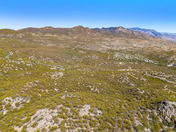 a view of a mountain range with a lush green hillside