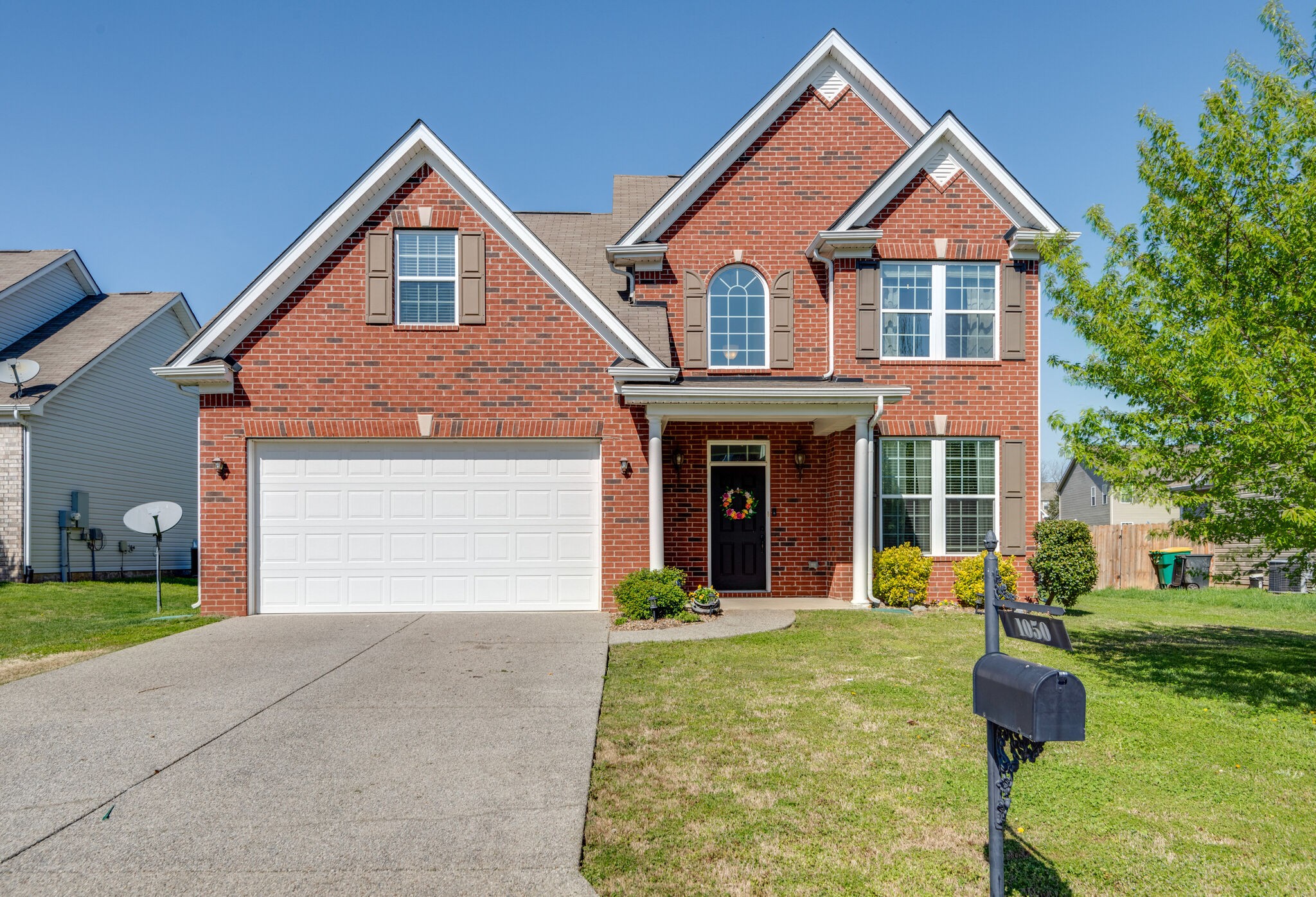 1050 Countess Lane Spring Hill, TN 37174 - Photo 1 of 22 a front view of a house with garden and garage
