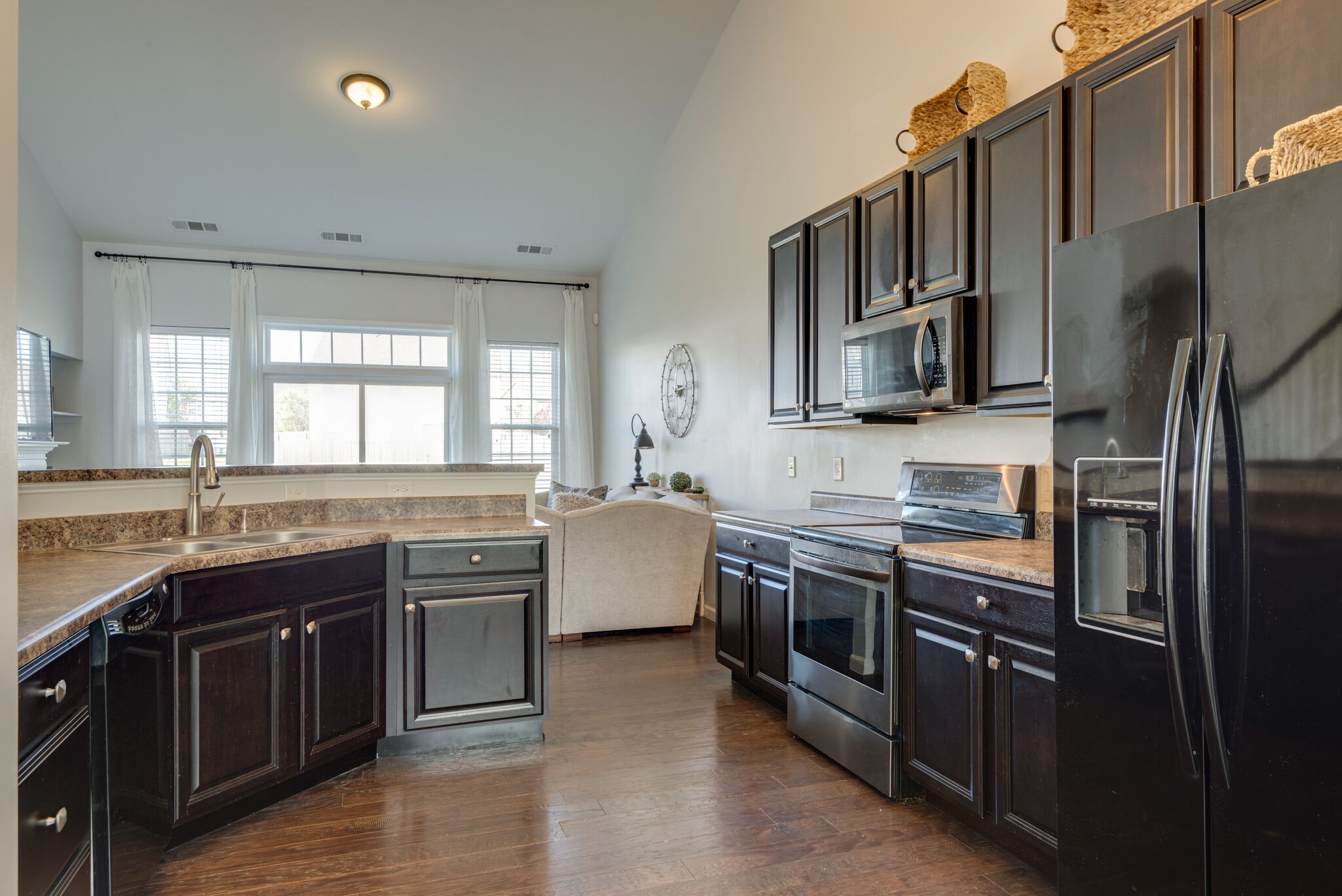 1050 Countess Lane Spring Hill, TN 37174 - Photo 11 of 22 a large kitchen with stainless steel appliances granite countertop a stove top oven a sink dishwasher a refrigerator and cabinets with wooden floor