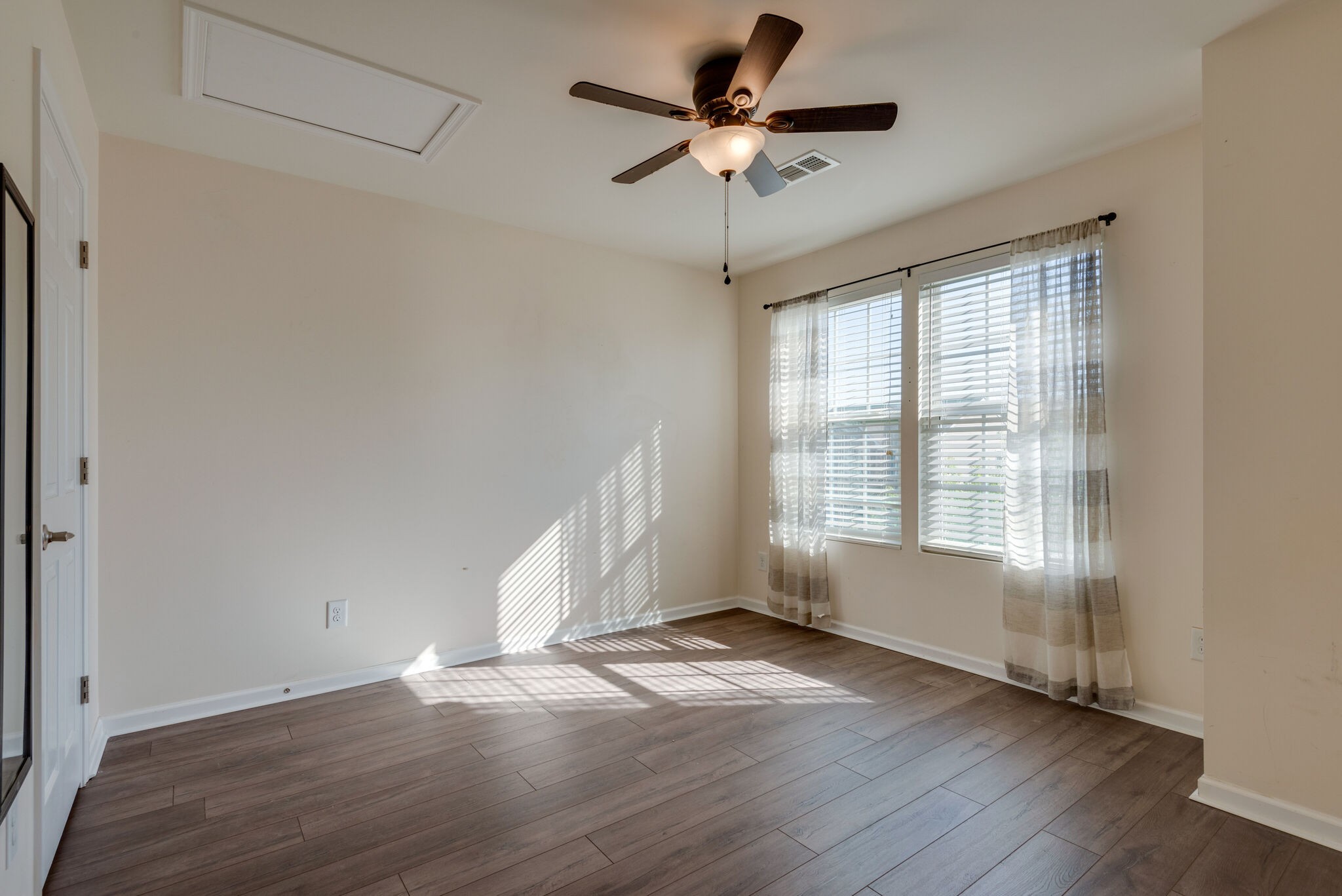 1050 Countess Lane Spring Hill, TN 37174 - Photo 20 of 22 an empty room with wooden floor and windows