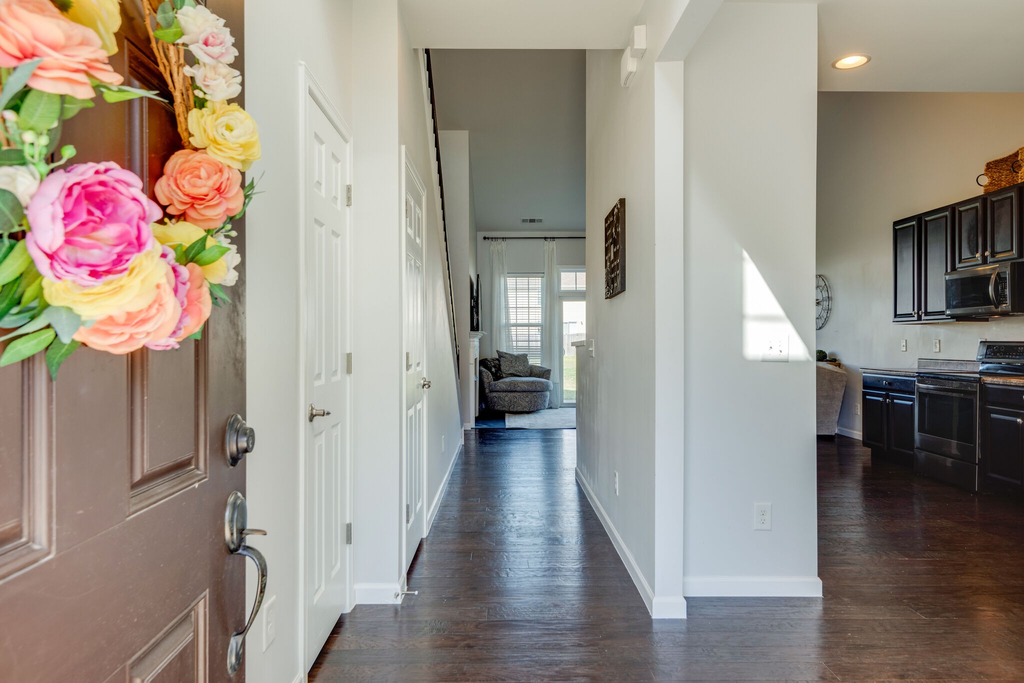 1050 Countess Lane Spring Hill, TN 37174 - Photo 3 of 22 a view of a hallway view with wooden floor and staircase