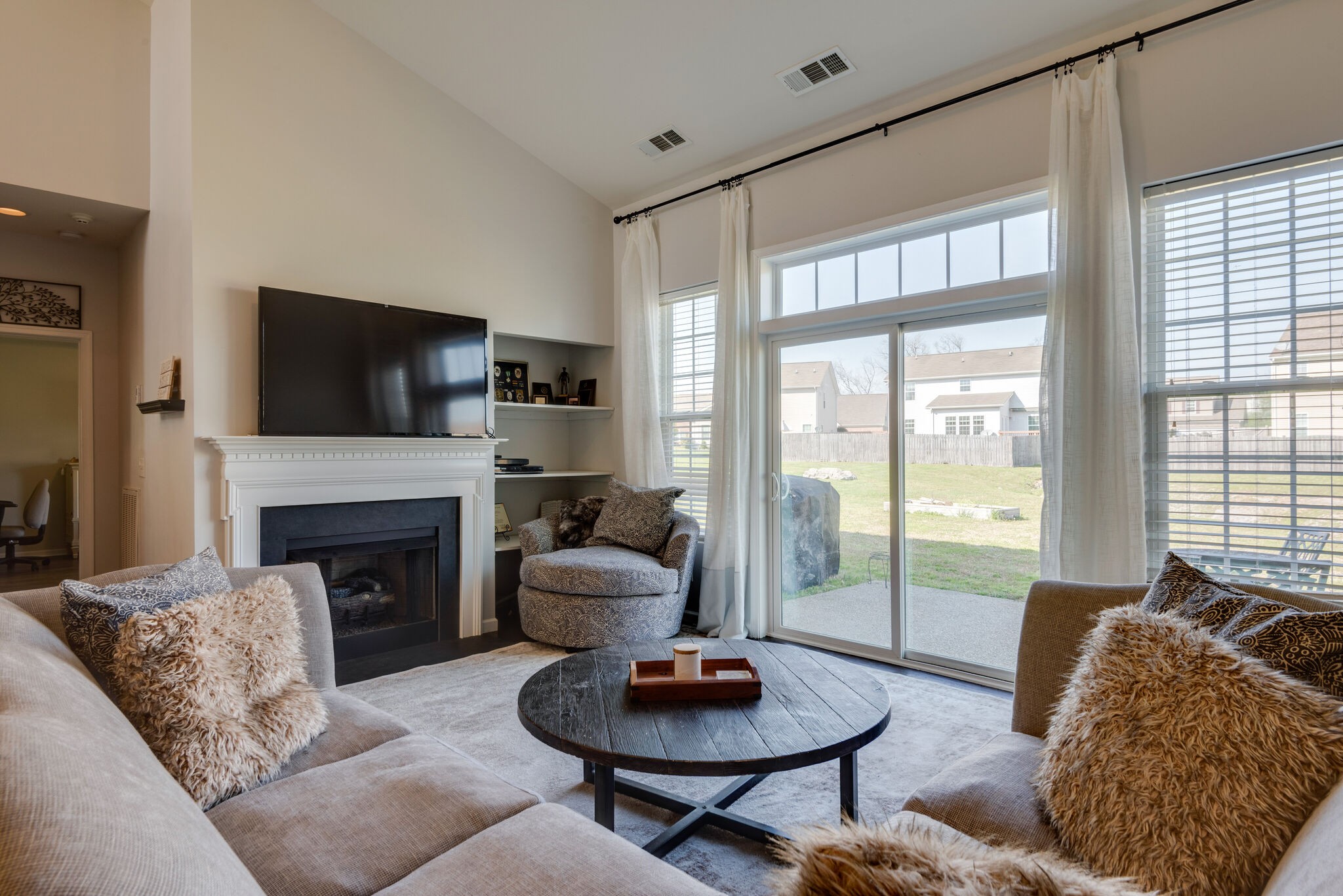 1050 Countess Lane Spring Hill, TN 37174 - Photo 8 of 22 a living room with furniture a fireplace and a flat screen tv