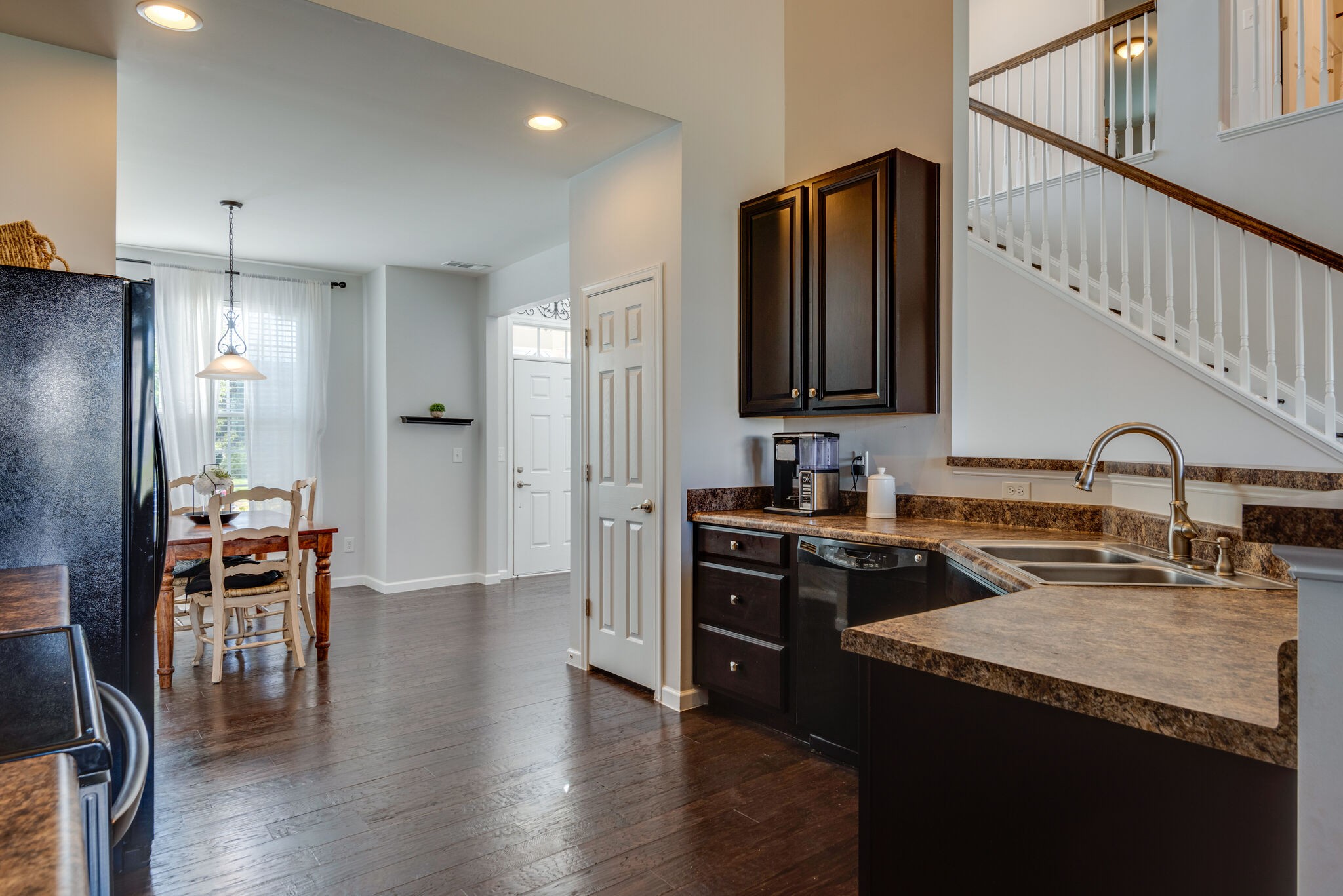 1050 Countess Lane Spring Hill, TN 37174 - Photo 10 of 22 a kitchen with granite countertop a refrigerator stove top oven and sink