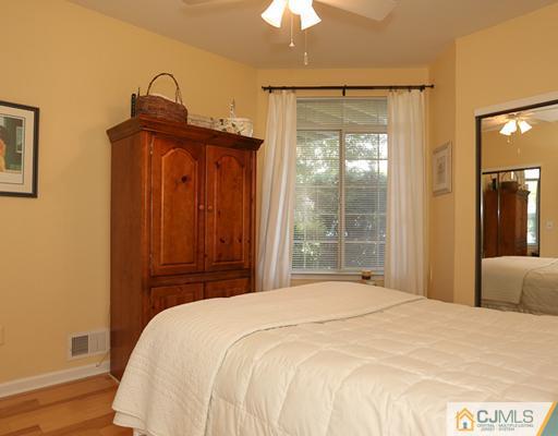 85 Wentworth Road Bedminster, NJ 07921 - Photo 11 of 20 a bedroom with a bed and a chandelier