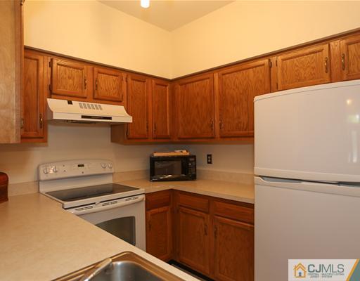 85 Wentworth Road Bedminster, NJ 07921 - Photo 10 of 20 a kitchen with a refrigerator and cabinets