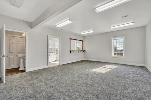 an empty room with windows and entrance
