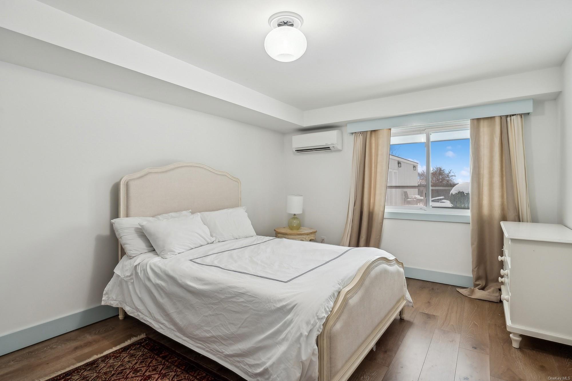 8 Big Reed Path Montauk, NY 11954 - Photo 12 of 39 a bedroom with a bed and window