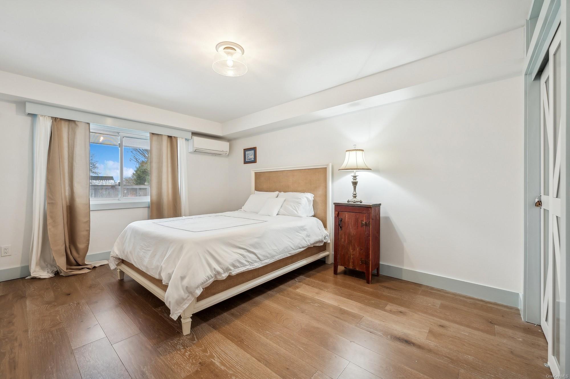 8 Big Reed Path Montauk, NY 11954 - Photo 14 of 39 a bedroom with a bed and wooden floor