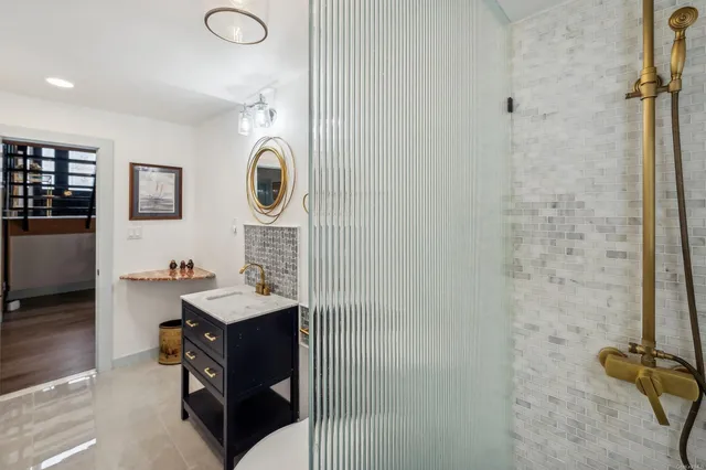 a bathroom with a sink a toilet and shower