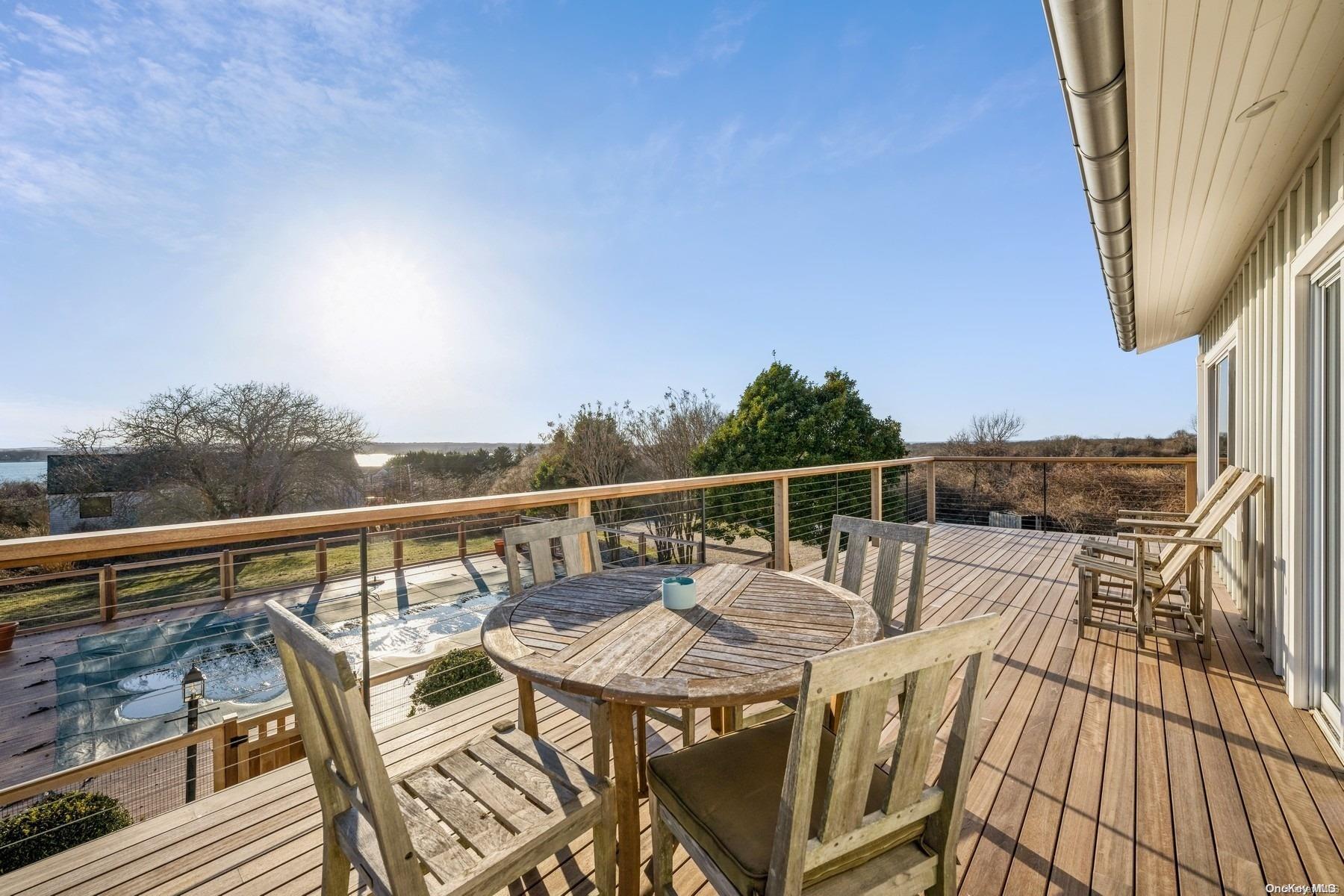 8 Big Reed Path Montauk, NY 11954 - Photo 19 of 39 a balcony with wooden floor table and chairs