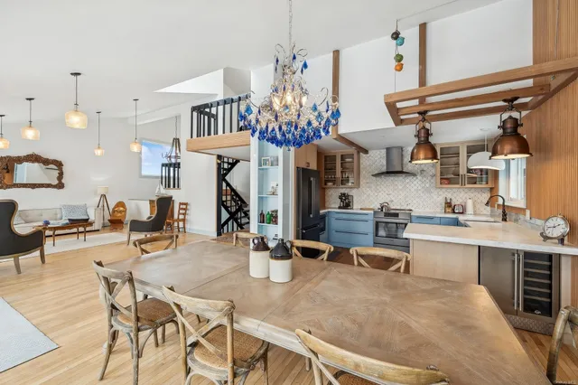 a living room with lots of furniture and kitchen view