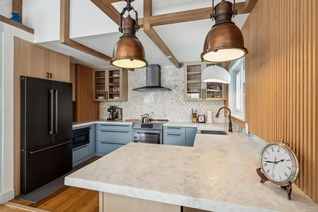 a kitchen with stainless steel appliances a stove a refrigerator and cabinets