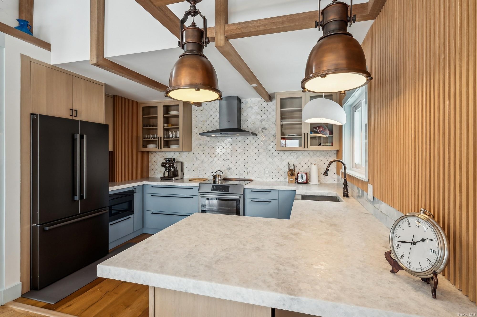 8 Big Reed Path Montauk, NY 11954 - Photo 22 of 39 a kitchen with stainless steel appliances a stove a refrigerator and cabinets