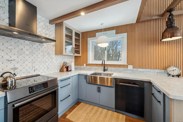 a kitchen with a sink stove and cabinets