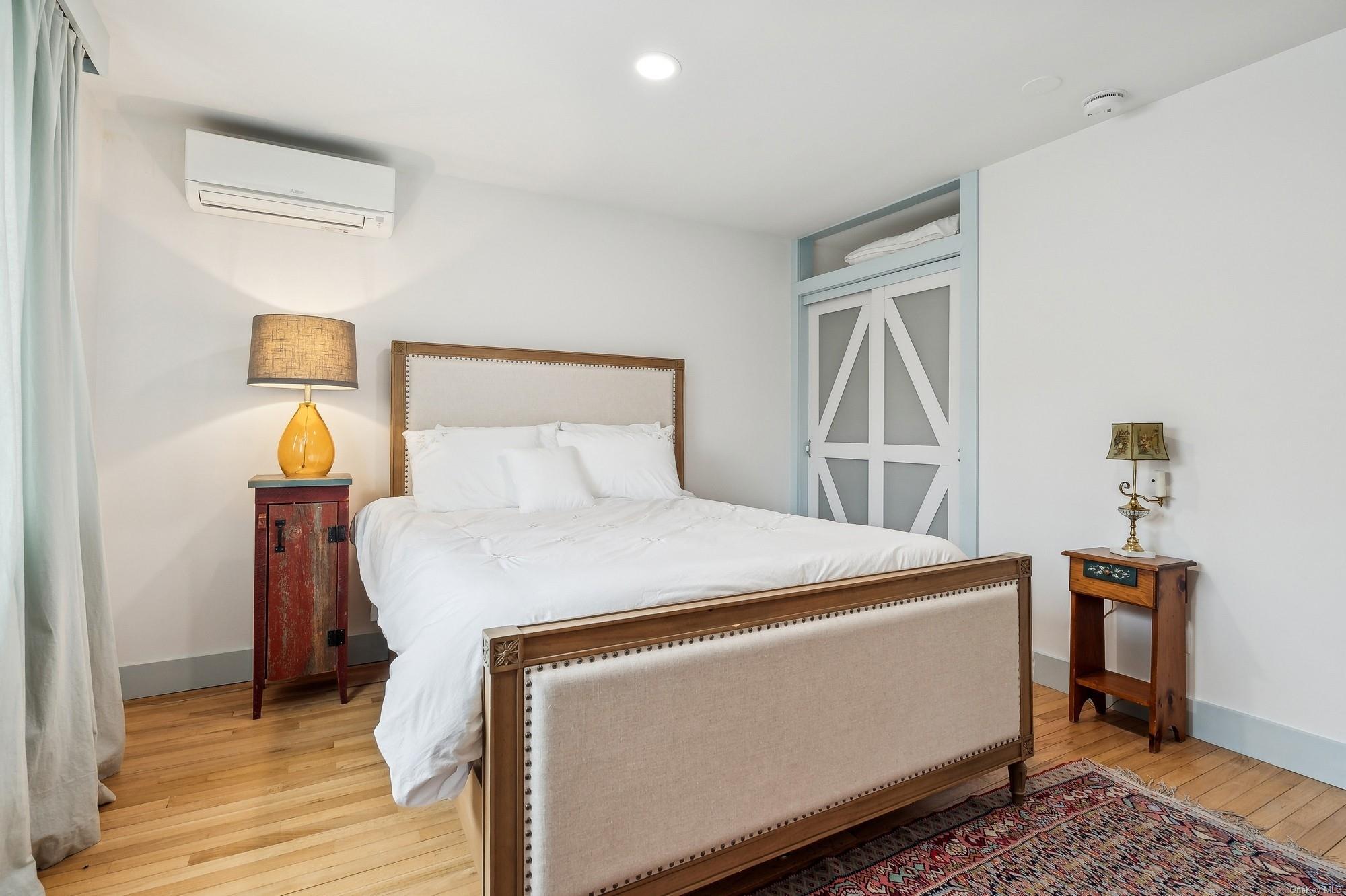 8 Big Reed Path Montauk, NY 11954 - Photo 29 of 39 a bedroom with a bed and wooden floor