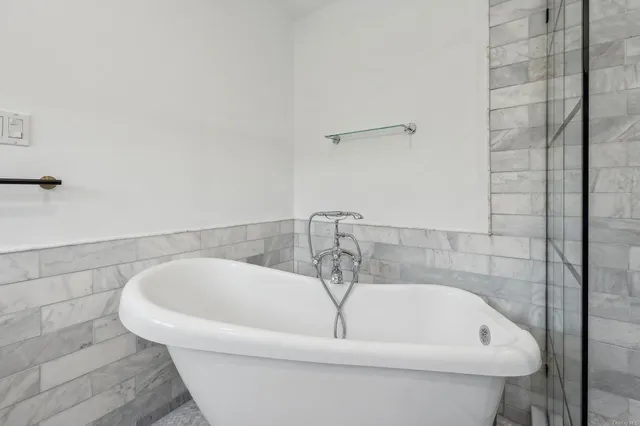 a white bath tub sitting in a bathroom