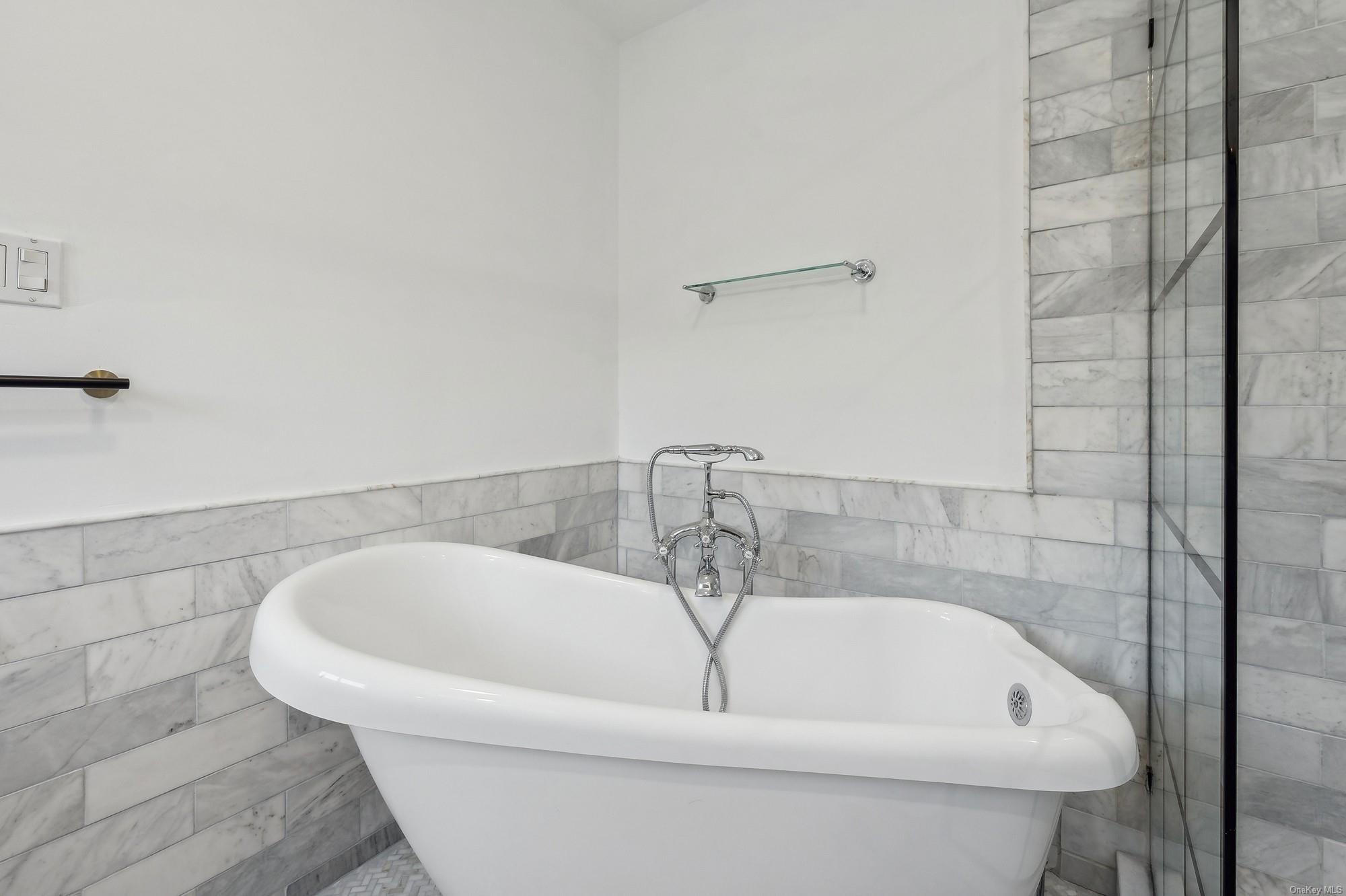 8 Big Reed Path Montauk, NY 11954 - Photo 32 of 39 a white bath tub sitting in a bathroom