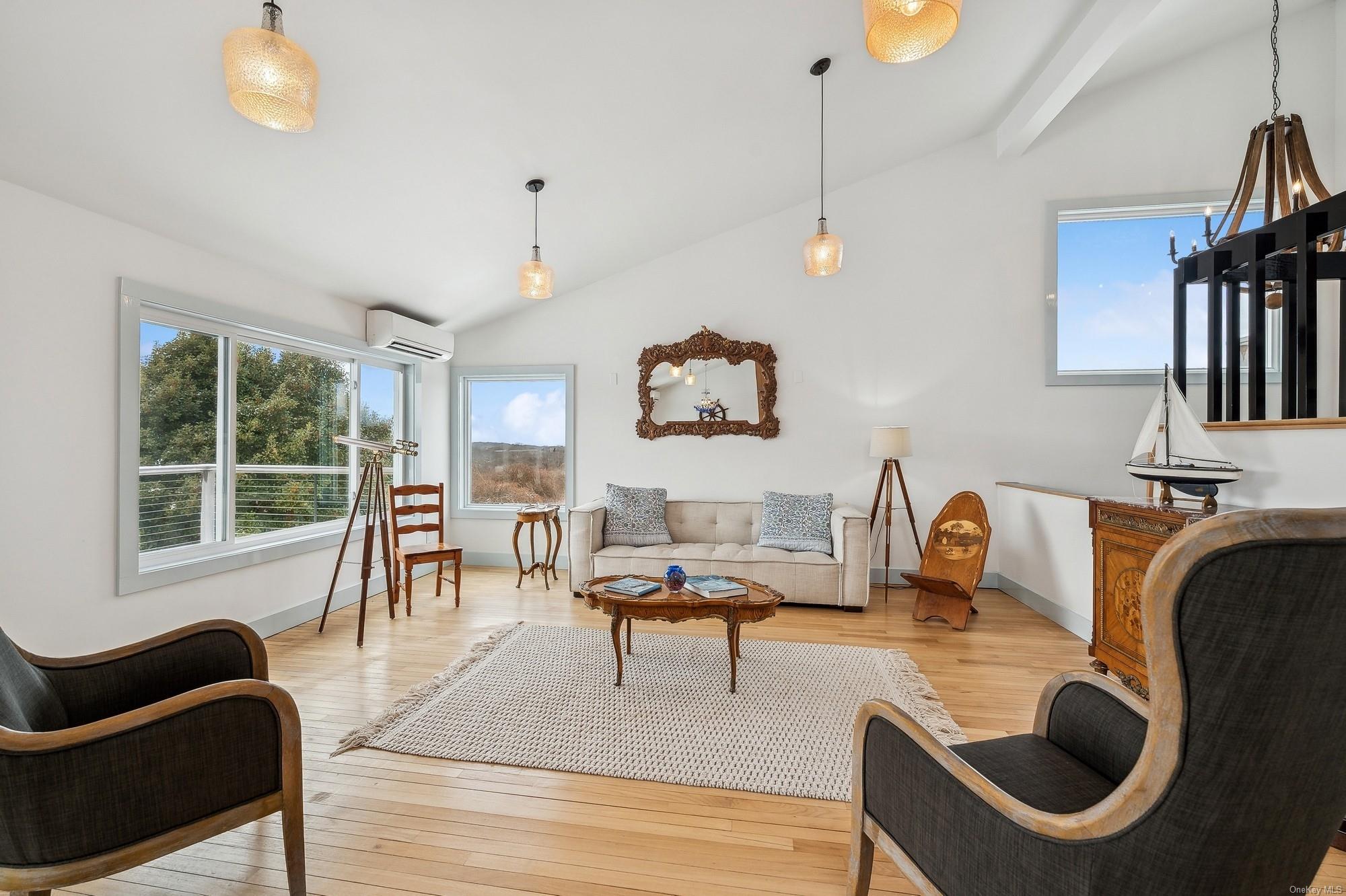 8 Big Reed Path Montauk, NY 11954 - Photo 6 of 39 a living room with furniture and a large window