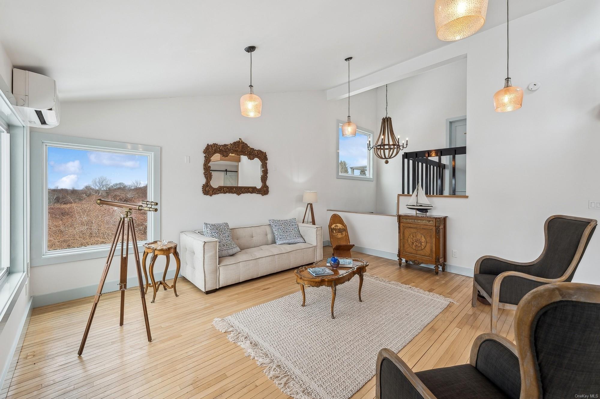 8 Big Reed Path Montauk, NY 11954 - Photo 7 of 39 a living room with furniture a rug and white walls