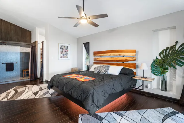 a bedroom with a bed and a chandelier