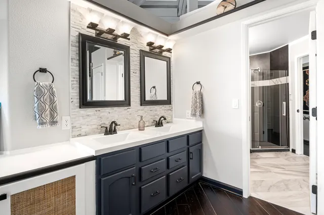 a bathroom with a double vanity sink mirror and