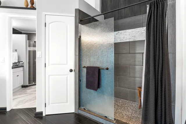 a bathroom with a glass shower door