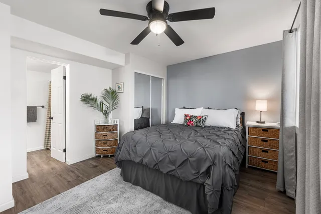 a bedroom with a large bed and a chandelier