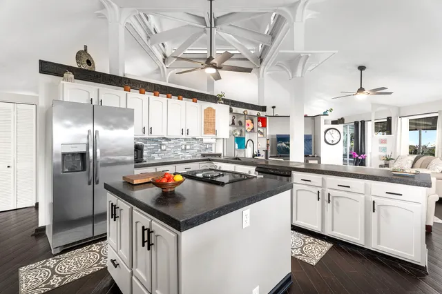 a kitchen with stainless steel appliances granite countertop a sink a stove and a refrigerator