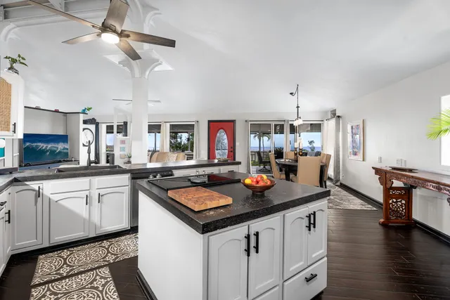 a kitchen with stainless steel appliances granite countertop a kitchen island a stove and a sink