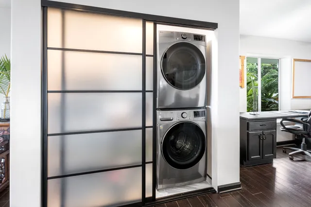 a view of a bedroom with washer and dryer