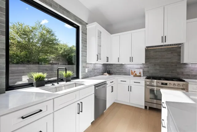a kitchen with a sink stove and cabinets